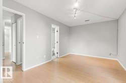 Light wood-finish flooring with white trim - 