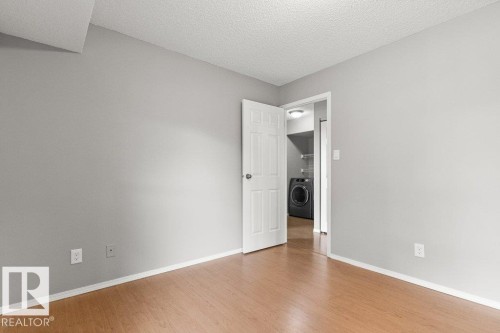 Wood-finish flooring with light gray wall paint - #4 14620 26 St Nw, Edmonton, AB 