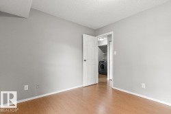 Wood-finish flooring with light gray wall paint - 