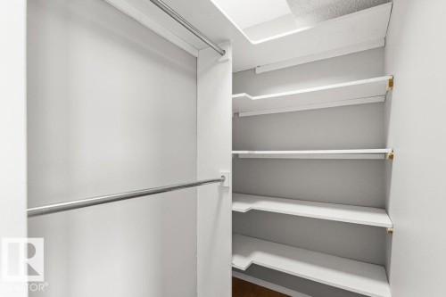 Built-in shelving, chrome hanging rods, and wood-finish flooring - #4 14620 26 St Nw, Edmonton, AB 