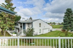 White vinyl siding exterior with an asphalt shingle roof - 
