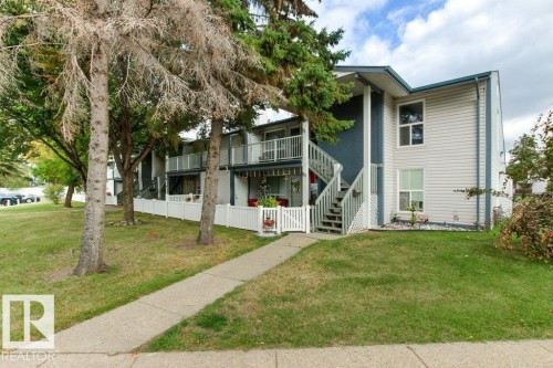 Multi-level building with light-colored siding and dark trim - #4 14620 26 St Nw, Edmonton, AB 