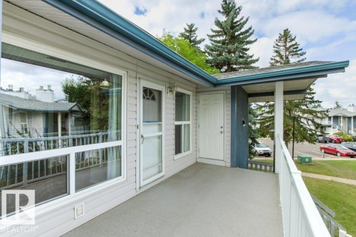 Outdoor balcony with durable railing, direct entry door, and large window - #4 14620 26 St Nw, Edmonton, AB 