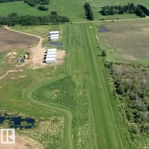 Expansive green landscape featuring a long, mown grass strip - 26453 Twp Rd 481, Rural Leduc County, AB 