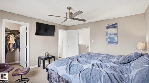 Neutral wall tones, built-in ceiling fan with integrated lighting, two panel interior doors, and carpeted flooring - 1709 64 Street Sw, Edmonton, AB 