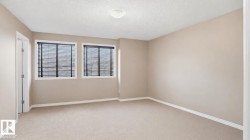 Neutral-toned walls complement carpeted flooring and white trim - 
