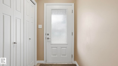 White panel doors, white trim, frosted glass door, light beige wall color, wood-finish flooring - 1709 64 Street Sw, Edmonton, AB 