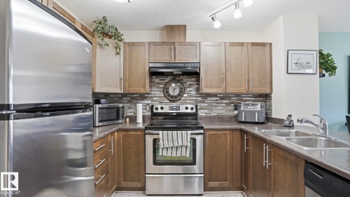 Stainless steel refrigerator, built-in oven, and dishwasher - 1709 64 Street Sw, Edmonton, AB 