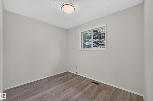 Neutral wall color, wood-finish flooring, white trim, and flush mount lighting - 3722 34A Avenue Nw, Edmonton, AB 