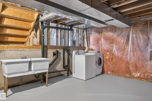 Utility area featuring a dual basin sink, concrete foundation walls, exposed wood framing, and painted concrete flooring - 3722 34A Avenue Nw, Edmonton, AB 