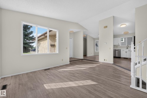Wood-finish flooring, white walls, and a large window - 3722 34A Avenue Nw, Edmonton, AB 