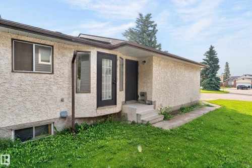 Exterior with textured stucco finish and multiple windows - 3722 34A Avenue Nw, Edmonton, AB 