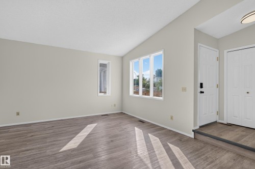 Vaulted ceiling, wood-finish flooring, multiple windows, white doors, recessed entry - 3722 34A Avenue Nw, Edmonton, AB 