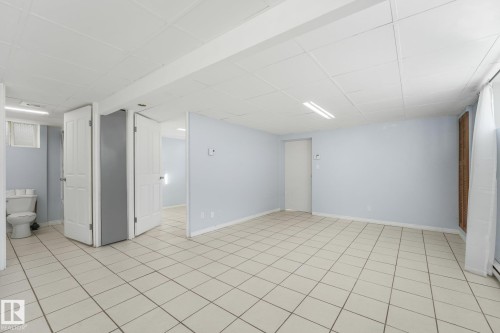 Tile flooring, drop ceiling, recessed lighting, white panel doors, and light blue wall color - 11841 71 Street Nw, Edmonton, AB 