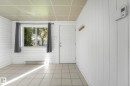 White paneled walls, tiled flooring, drop ceiling, and a functional window - 11841 71 Street Nw, Edmonton, AB 