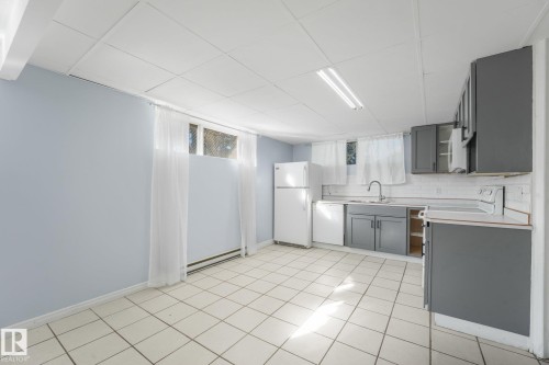Tile flooring, light blue wall paint, window, gray cabinetry, white subway tile backsplash - 11841 71 Street Nw, Edmonton, AB 