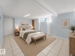 Light blue walls with white trim, tile flooring, drop ceiling with integrated lighting, and a window with sheer white curtains - 