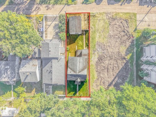 Property featuring a main residence with a gabled roof, an additional detached structure with a gabled roof, and a grassy lawn space - 11841 71 Street Nw, Edmonton, AB 