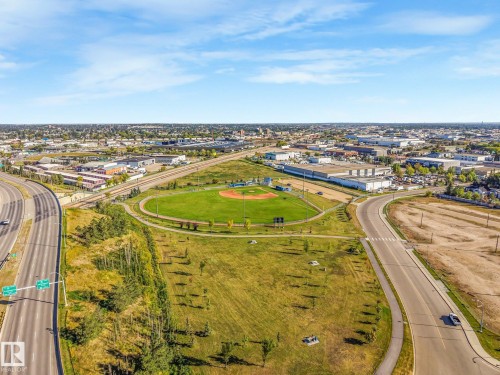 Expansive urban landscape featuring a baseball field, extensive road infrastructure, and distant commercial buildings - 11841 71 Street Nw, Edmonton, AB 