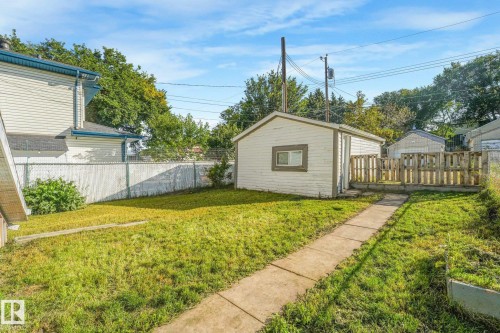 Detached garage with wood fencing and a concrete walkway - 11841 71 Street Nw, Edmonton, AB 