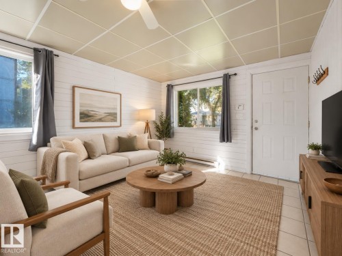 Recessed panel ceiling, wood-finish accent wall, ceiling fan, and tile flooring - 11841 71 Street Nw, Edmonton, AB 