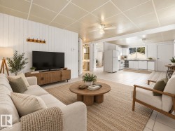 Open-concept living area with white paneled walls, white tile flooring, and a kitchen featuring white appliances - 