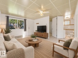 Recessed panel ceiling, ceiling fan, tile flooring, built-in shelving, and shaker panel doors - 