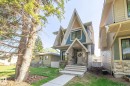 Contemporary exterior with A-frame architectural elements, stone facade, blue and tan siding, and concrete front steps - 9111 65 Avenue Nw, Edmonton, AB 