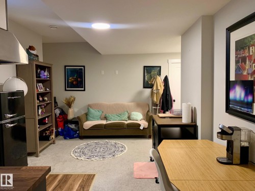 Recessed overhead lighting, light gray wall paint, wood-finish flooring, white doors, and light gray carpeting - 9111 65 Avenue Nw, Edmonton, AB 