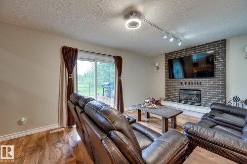 #100 22549 Twp Rd 510, Rural Leduc County, AB - Indoor Photo Showing Living Room With Fireplace