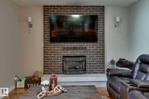 #100 22549 Twp Rd 510, Rural Leduc County, AB - Indoor Photo Showing Living Room With Fireplace