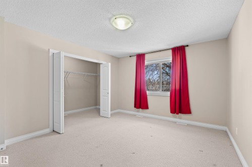 Neutral painted walls with textured ceiling and wall-to-wall carpeting - 15504 102 Avenue Nw, Edmonton, AB 