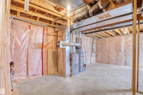 Unfinished basement with exposed ceiling joists, concrete flooring, and insulated walls - 15504 102 Avenue Nw, Edmonton, AB 