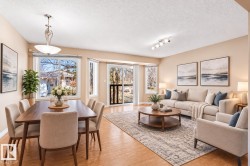 Open-concept living and dining areas featuring wood-finish flooring, bay windows, track lighting, and a sliding glass door - 