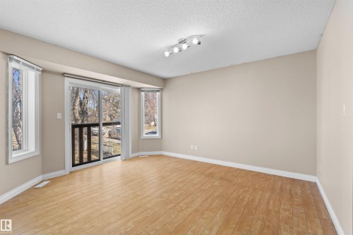 Light wood-finish flooring with neutral wall tones - 15504 102 Avenue Nw, Edmonton, AB 