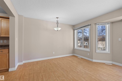 Recessed ceiling, wood-finish flooring, two large windows, built-in cabinetry, and a ceiling-mounted light fixture - 15504 102 Avenue Nw, Edmonton, AB 