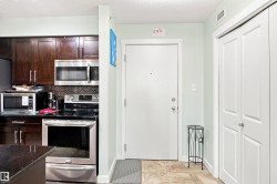 Kitchen featuring wood-finish cabinetry, stainless steel appliances, and a tiled backsplash - 