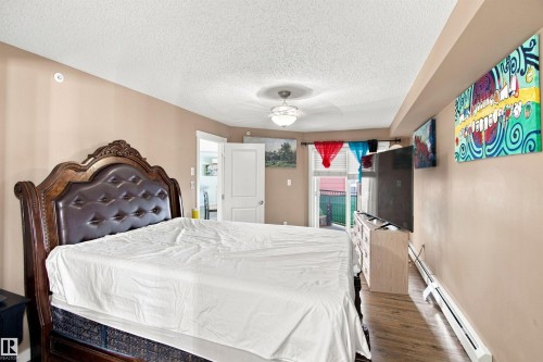 Wood-finish flooring, light-toned walls, and a ceiling-mounted light fixture - #413 18126 77 St Nw, Edmonton, AB 