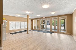 Entrance foyer with wood-finish flooring, flush mount lighting, and large window panels - 