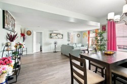 Wood-finish flooring, recessed lighting, and a chandelier-style fixture - 