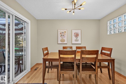 Hardwood flooring, contemporary chandelier, glass block window, neutral wall paint, white sliding glass door - 17919 78 Avenue Nw, Edmonton, AB 