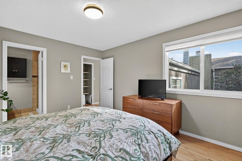 Wood-finish flooring, white trim, and a built-in closet with shelving - 17919 78 Avenue Nw, Edmonton, AB 