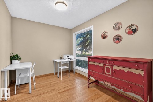 Hardwood flooring, neutral painted walls, white trim, and a large window - 17919 78 Avenue Nw, Edmonton, AB 