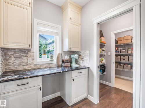 A perfectly appointed butler's kitchen — the ultimate convenience. Whether you're looking for a dedicated space to prep meals, blend smoothies, or simply want extra room away from the main kitchen, this home has thought of everything. - 3711 Westcliff Way Sw, Edmonton, AB 