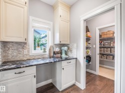 A perfectly appointed butler's kitchen — the ultimate convenience. Whether you're looking for a dedicated space to prep meals, blend smoothies, or simply want extra room away from the main kitchen, this home has thought of everything. - 