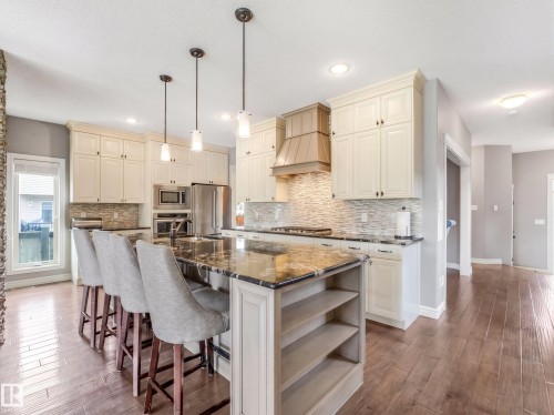 A beautifully upgraded home featuring premium appliances and finishes, including a sleek built-in countertop gas stove and upgraded hood fan - all thoughtfully chosen to maximize comfort and safety. - 3711 Westcliff Way Sw, Edmonton, AB 