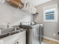 Upstairs, you’ll appreciate the convenience of a dedicated laundry room, complete with a laundry sink — making laundry days effortless and keeping everything perfectly organized. - 