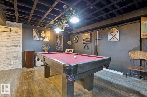 chic recreation room with a fridge, stove,  a wet bar and lots of room for pool table and other games - 11452 39 Avenue Nw, Edmonton, AB 