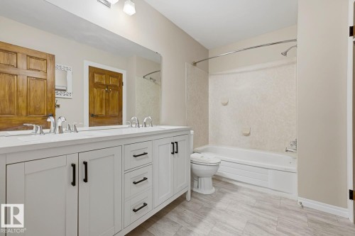 Double vanity with white cabinetry and matte black hardware - 10621 Beaumaris Road Nw, Edmonton, AB 