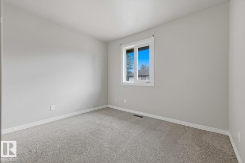 Neutral paint palette with wall-to-wall carpeting and white trim - 10621 Beaumaris Road Nw, Edmonton, AB 